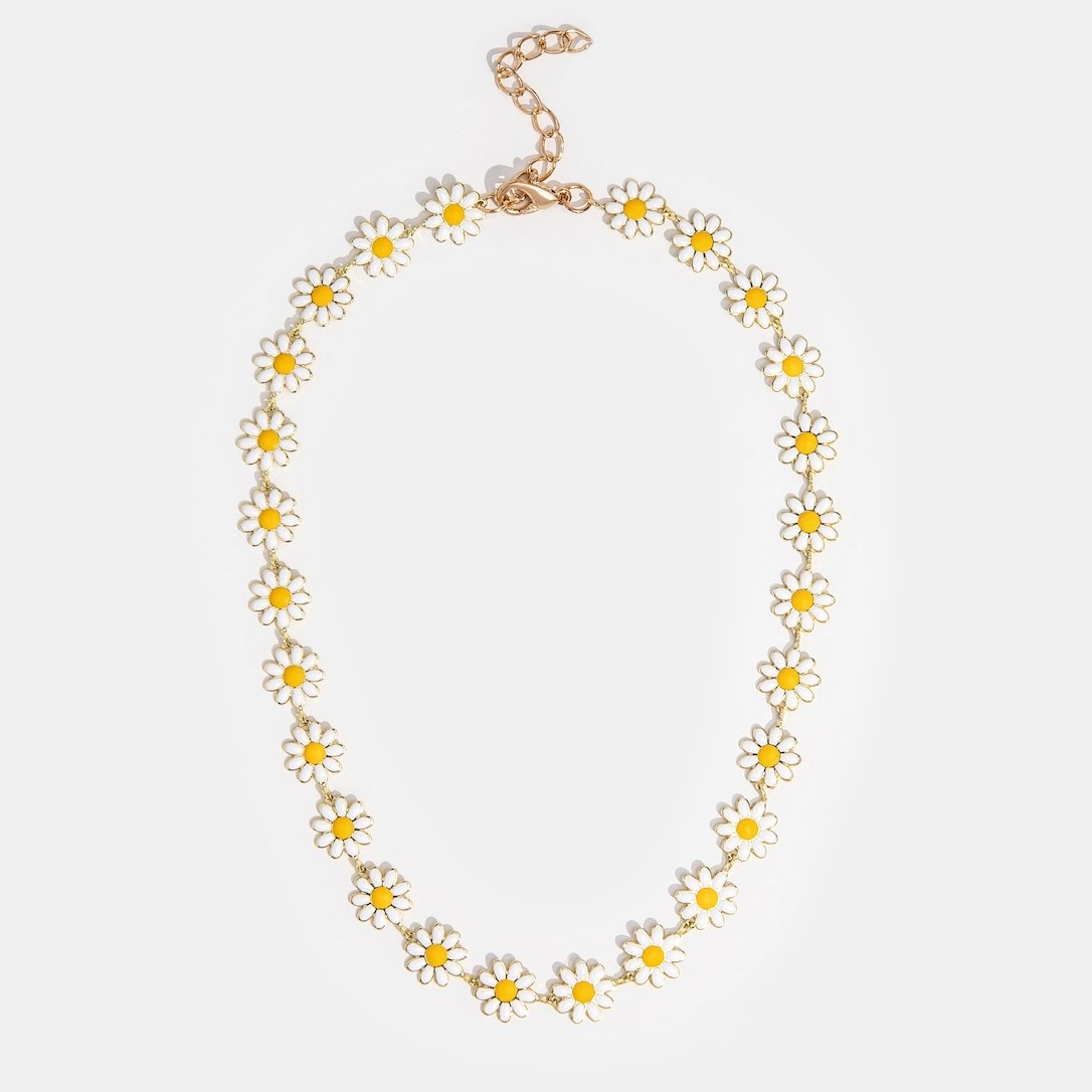 Close up of white daisy flower necklace with enamel petals and gold plated links